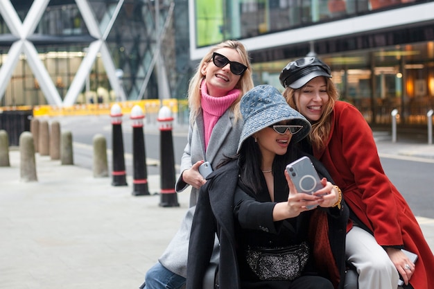 Internet celebrity taking a selfie with friends while sitting on a bench