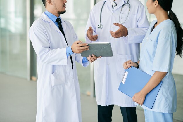 Interns consultng with doctor