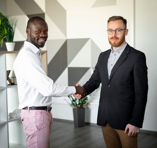 Free photo interracial colleagues shaking hands