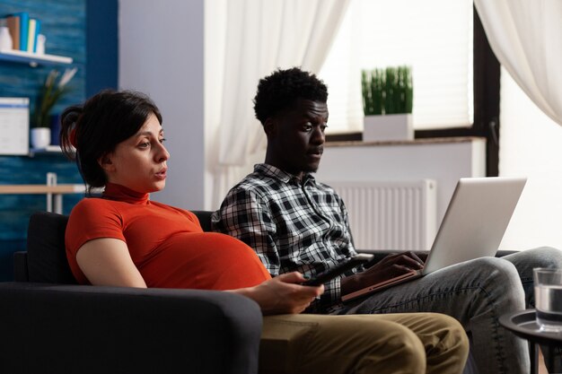 Interracial couple expecting child and using technology