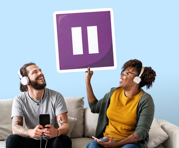 Interracial couple listening to music and holding a pause button