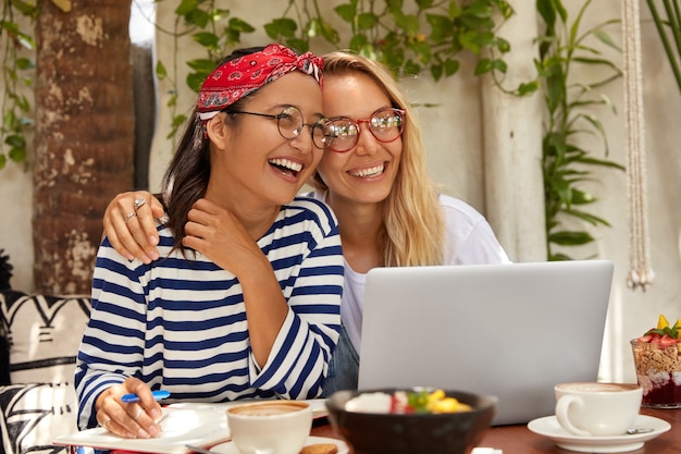 Free photo interracial groupmates write down information from internet website, have friendly relations