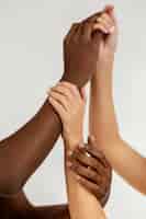 Free photo interracial hands holding each other close-up
