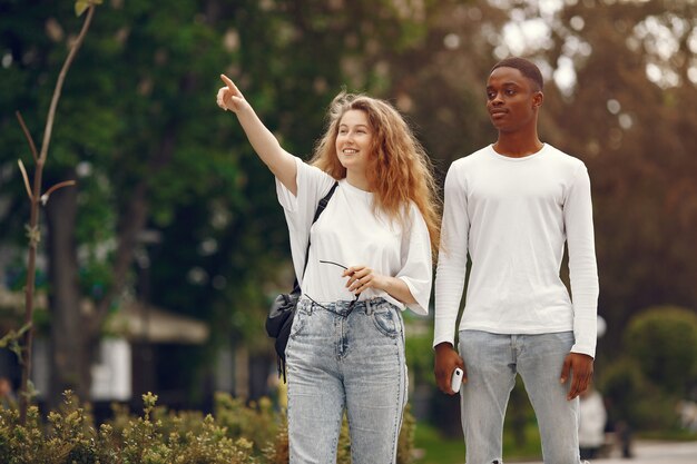 Interracial students has a fun and laughs cheerfully in park