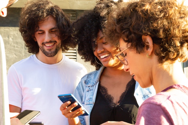 Free photo interracial team of friends standing in circle