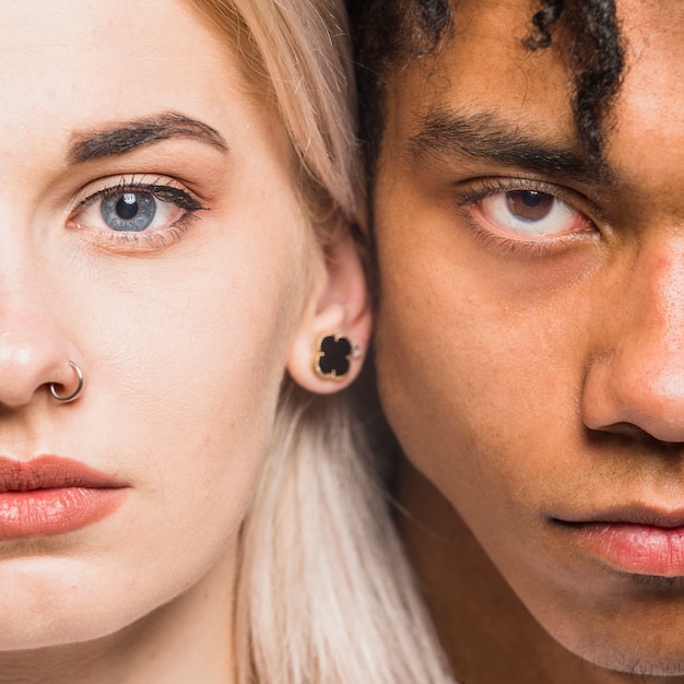 Interracial young couple face looking at camera
