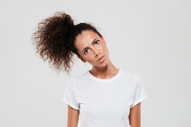 Free photo interrogative curly woman