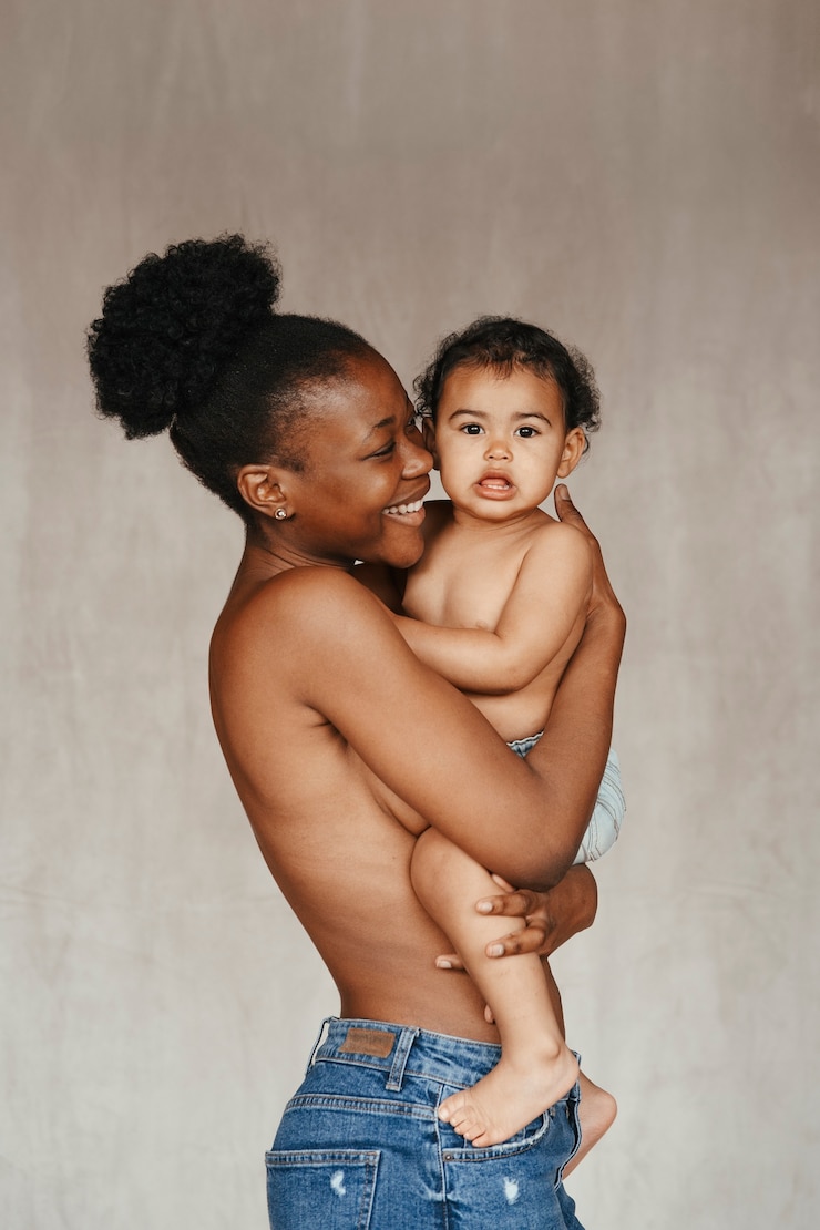 Free Photo intimate portrait of beautiful mother holding her baby