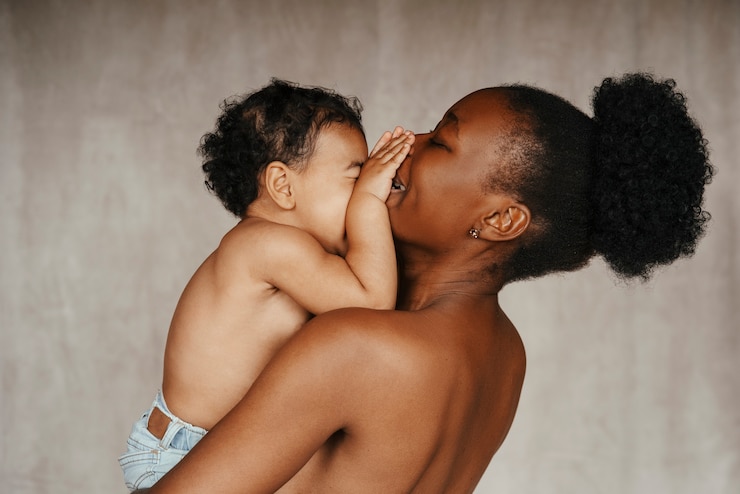 Free Photo intimate portrait of beautiful mother holding her young child
