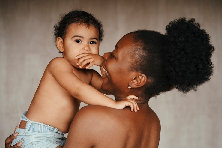 Free Photo intimate portrait of beautiful mother holding her young child