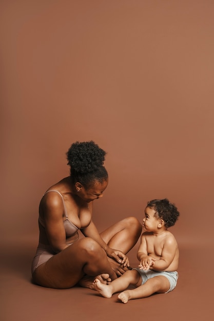 Free photo intimate portrait of beautiful mother holding her young child