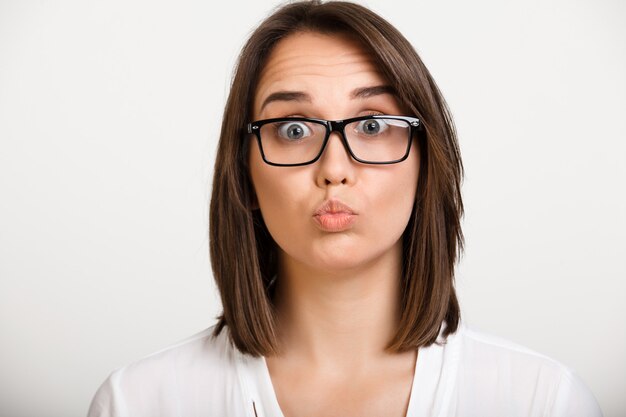 Intrigued young woman in glasses