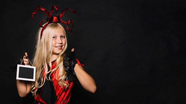 Free photo irl in costume holding blackboard and gesturing thumb-up