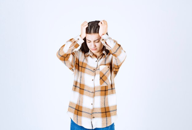  irritated young girl model holding her head and suffering from ache . 