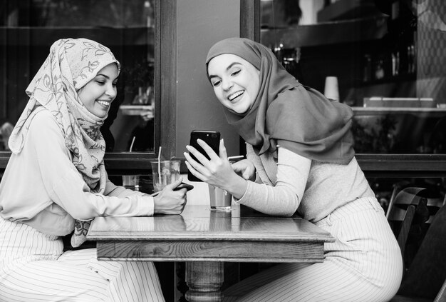 Islamic friends talking and looking on the smart phone