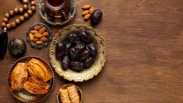 Islamic new year decoration with praying beads and snacks