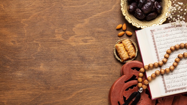 Free photo islamic new year decoration with praying beads on top of open book