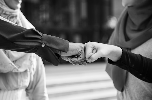 Islamic women friends fist bumps