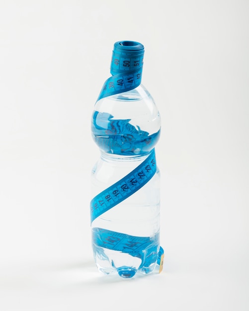 Isolated bottle of water and blue centimetre