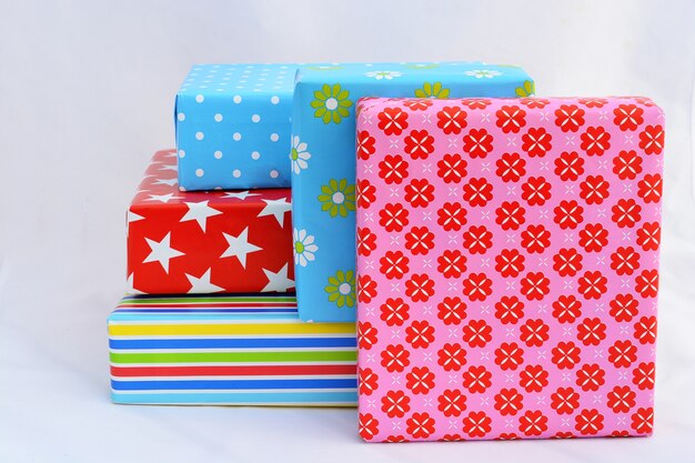 Isolated closeup shot of gift boxes in colorful wrapping stacked on top of and next to each