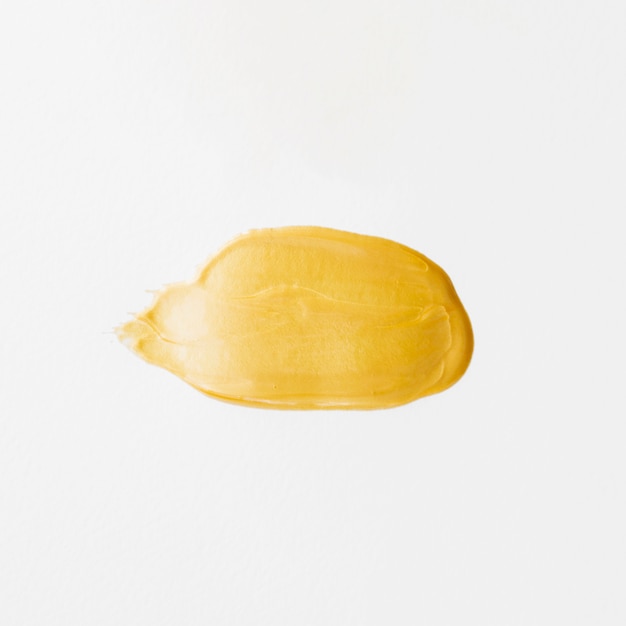 Isolated drop of gold paint