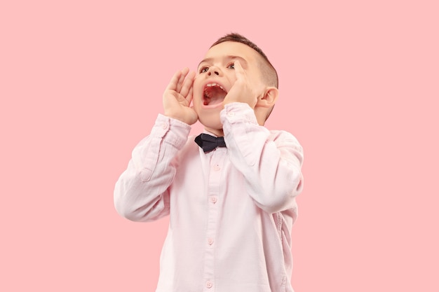 Isolated on pink young casual boy shouting at 