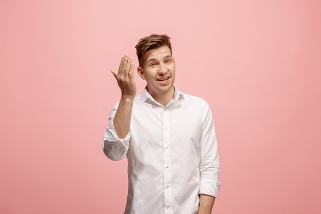 Isolated on pink young casual man shouting at studio