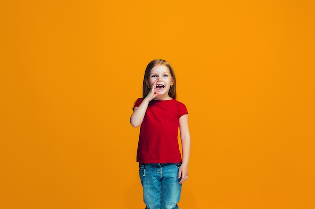 Isolated on pink young casual teen girl shouting at studio