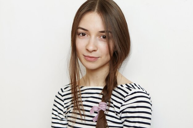 Isolated portrait of charming young lady in striped top