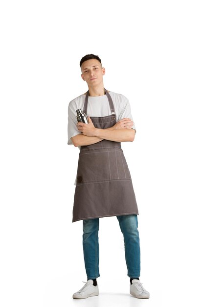 Isolated portrait of a young male caucasian barista in brown apron