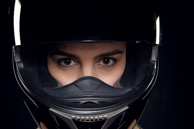 Isolated shot of attractive young brown eyed Caucasian female rider posing in studio