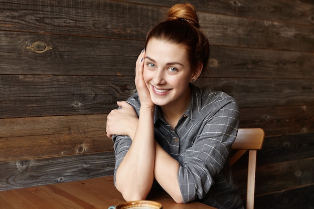 Isolated shot of beautiful redhead woman with charming smile