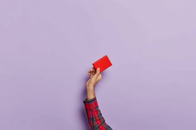 Isolated shot of man hands with empty little red paper box for accessory