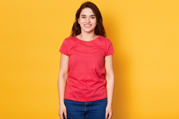 Isolated shot of pretty adult brunette girl with broad smile