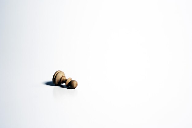 Isolated shot of a white chess pawn on a white background