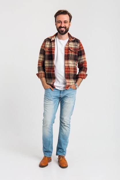 Isolated smiling handsome bearded man in hipster outfit dressed in jeans