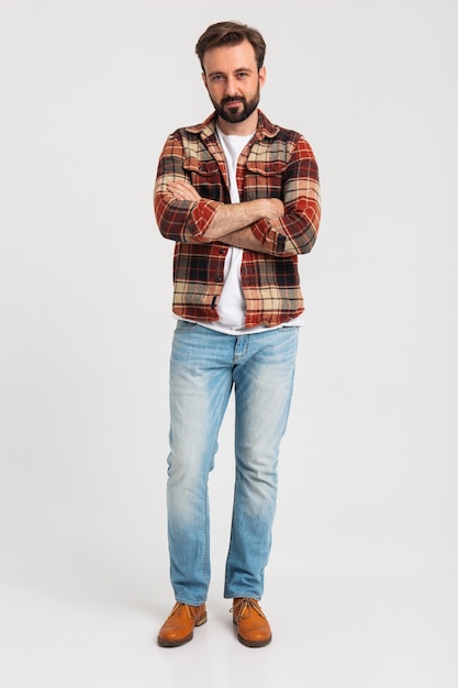 Isolated smiling handsome bearded man in hipster outfit dressed in jeans