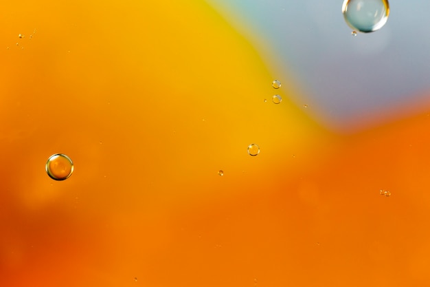 水っぽい背景に分離された石鹸の油の泡
