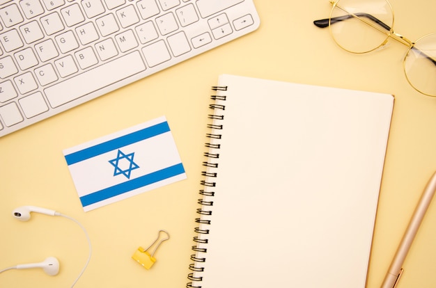 Israel flag next to empty notebook