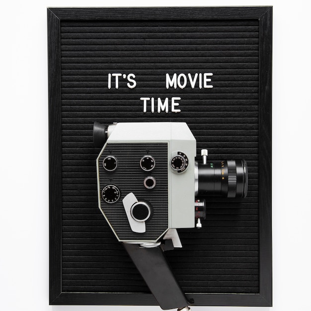 It's movie time lettering above vintage movie camera