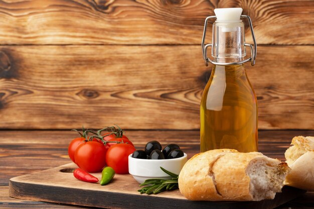 Italian ciabatta bread with olive oil on wooden background