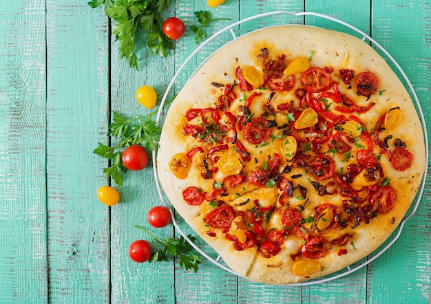 Italian focaccia with tomatoes, peppers and onions.