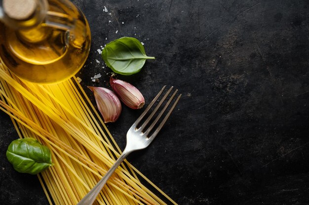 Italian food background with spaghetti spices and sauce View above