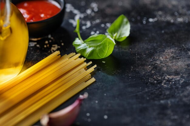 Italian food background with spaghetti spices and sauce View above