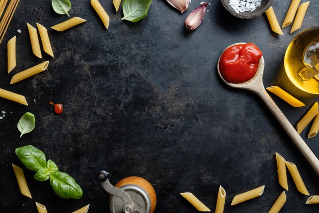 Italian food background with spaghetti spices and sauce View above