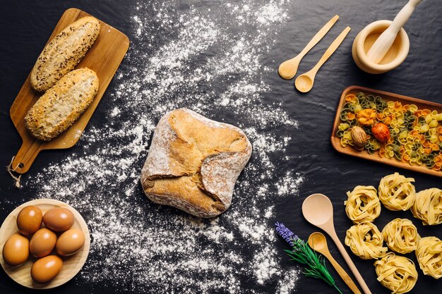 Italian food decoration with bread, eggs and pasta