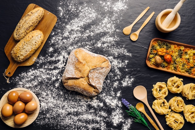 Italian food decoration with bread, eggs and pasta