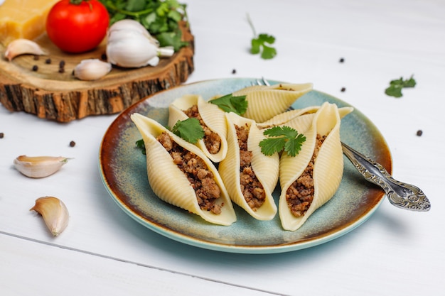 Italian pasta Conchiglioni Rigati stuffed with meat.