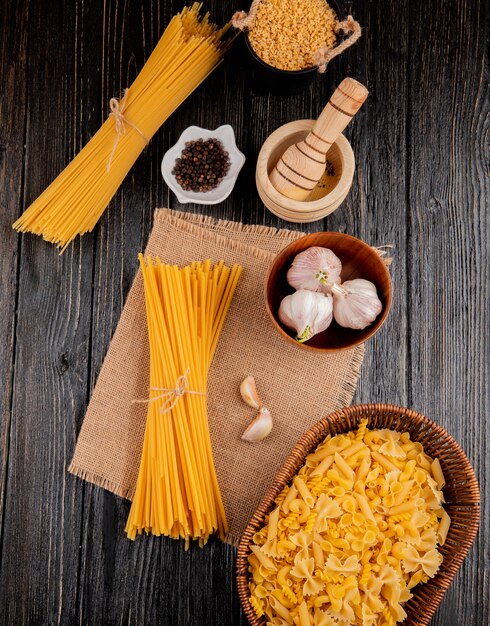 Italian pasta stelline spaghetti mortar linguini garlic mixed penne farfalle rotini top view