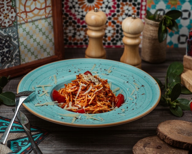 Italian pasta with tomato sauce inside blue authentic bowl 